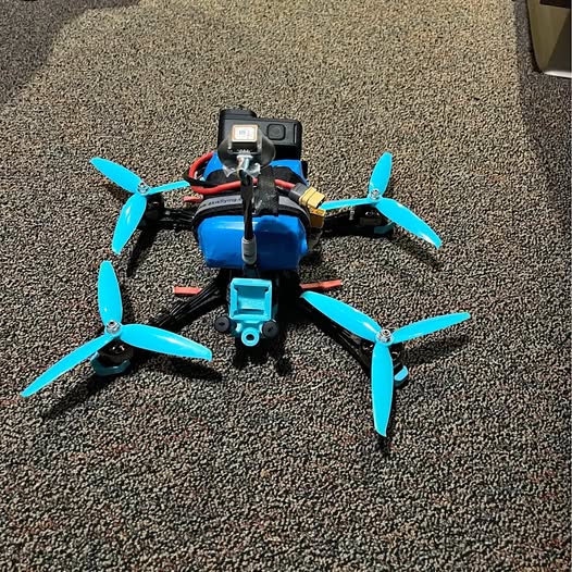 DJI FPV long-range quadcopter drone with four blue propellers