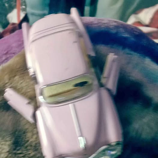 Lavender diecast car model with front grille, windshield, and side details