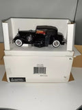 Black vintage diecast car in display box with plastic window