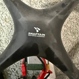 Remote control drone underside with landing arms and SNARTAIN logo