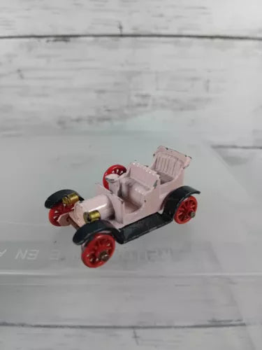 Vintage diecast spyker toy car with red metal wheels and light pink body