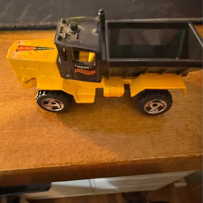 Yellow diecast snow plow model truck with gray blade and black wheels