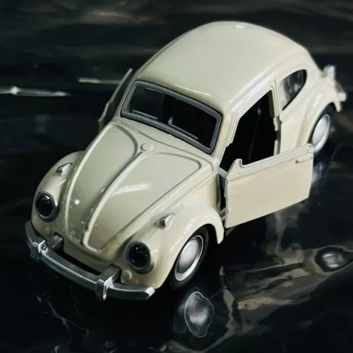 1:36 scale Volkswagen Beetle metal diecast model car, cream color, front three-quarter view