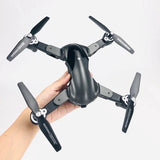 Black quadcopter drone with four propellers and foldable arms
