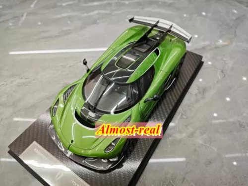 Green resin diecast sports car model with raised rear wing, on display base