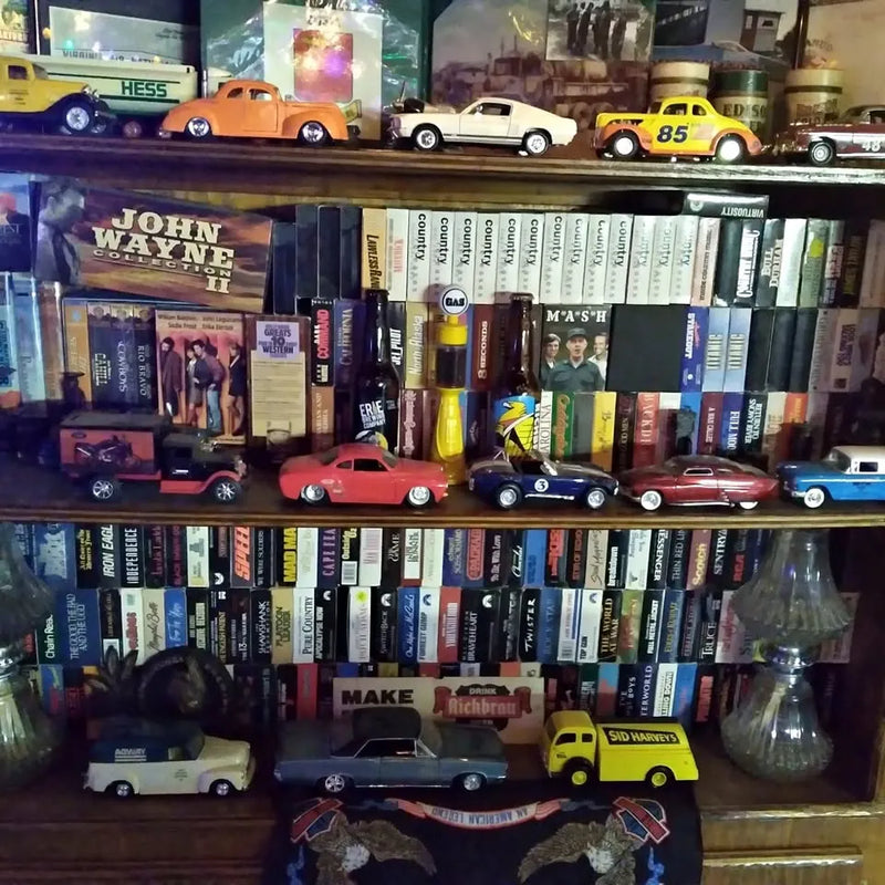 Diecast car collection with multiple miniature cars displayed on a shelf