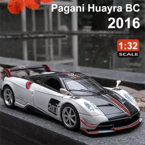 Silver diecast sports car model with black stripes, red trim, front 3/4 view