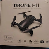 Foldable black quadcopter drone with four propellers and landing legs