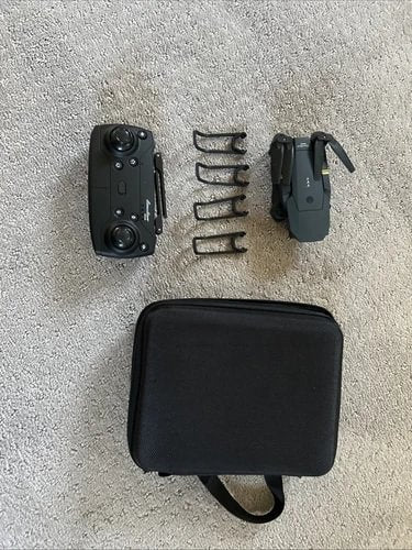 Drone charging kit with black hard case, charger, and cables