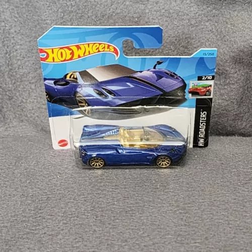 Blue die-cast sports car with gold wheels, shown in retail box