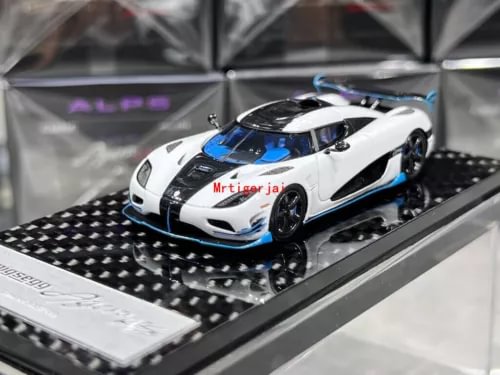 1:64 scale sports diecast car model, white with blue accents, on black checkered base