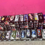 Diecast car collection in display boxes, multiple racing cars shown in rows
