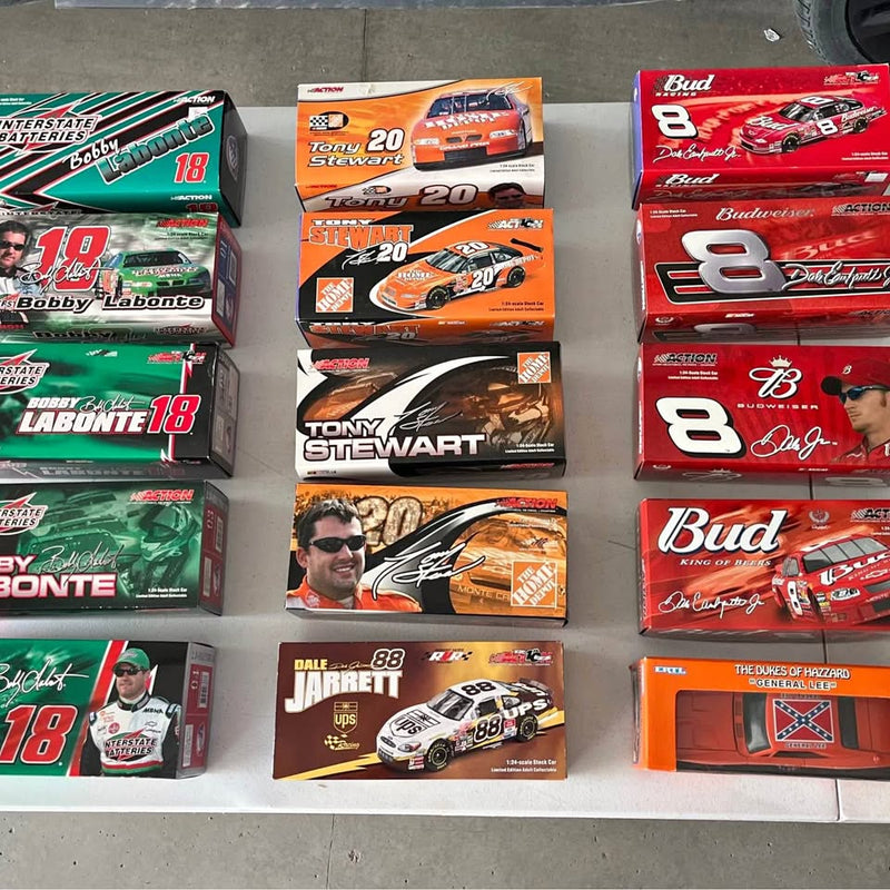 Boxed NASCAR diecast race car models, multiple team designs shown
