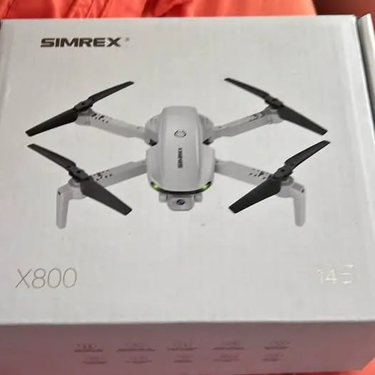 SIMREX small white quadcopter drone with six propeller arms and camera body