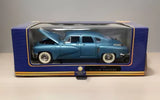 Blue diecast model car in display box, front view with chrome wheels