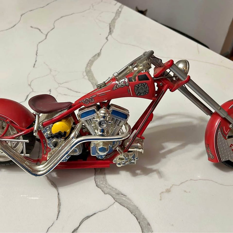 Red diecast motorcycle model with chrome engine and handlebars