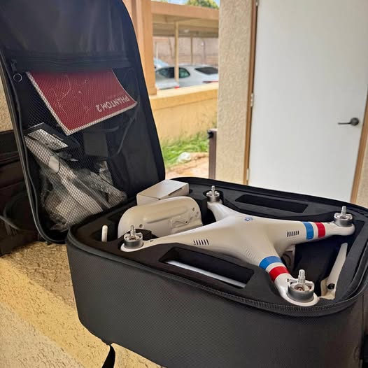 Off-white quadcopter drone in gray zippered carrying case