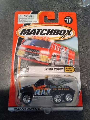 Matchbox diecast tow truck model in blister pack, blue and black with red details