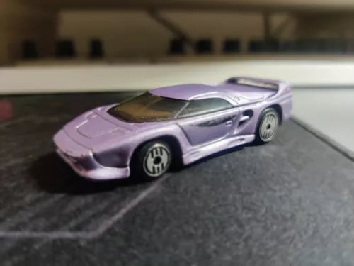 Vintage-style diecast toy car in purple and silver, front three-quarter view