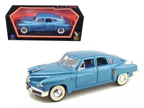 Light blue 1948 Tucker torpedo diecast model car, front three-quarter view in box