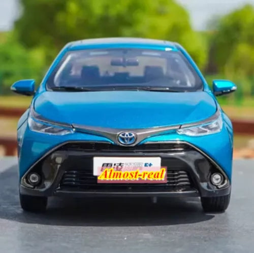 Blue diecast model car ornament, front view with Toyota emblem and grille detail