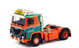 Orange and teal diecast model truck cab with black grille and chrome details