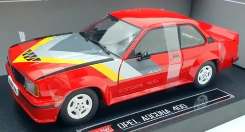 Red 1/18 scale diecast race car with yellow and white stripes, front three-quarter view