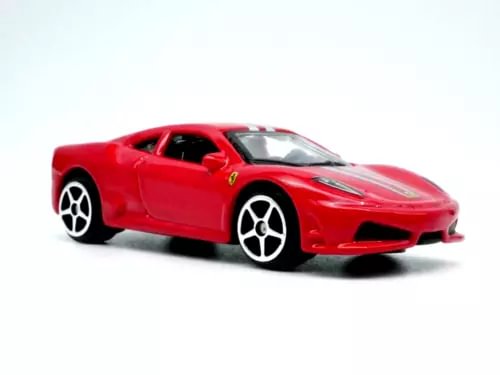 Red diecast model sports car with black hood and Ferrari shield on side