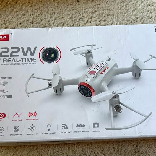 White quadcopter drone with front camera and four rotors