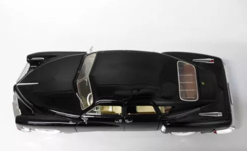 Black diecast car model with doors open, showing interior details
