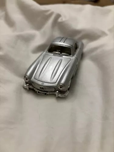 Gray 1:32 diecast model toy car with sculpted hood, front view