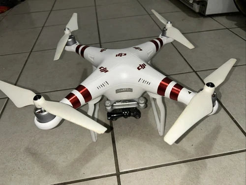 White quadcopter drone with red stripes, four propellers and mounted camera