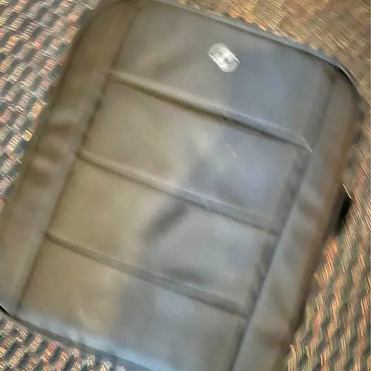 Drone body panel in light gray with raised seams and round indicator spot