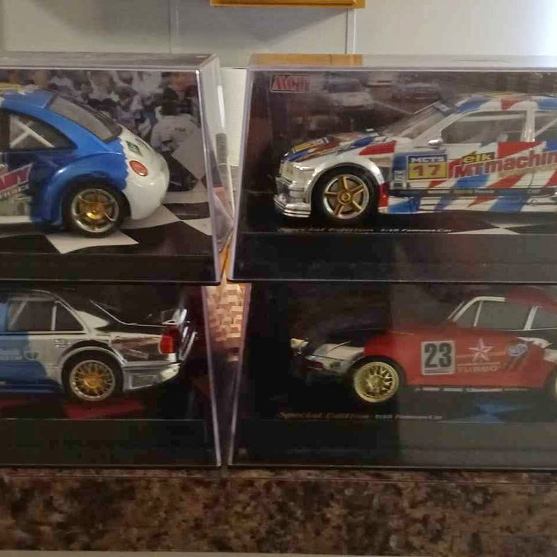 1:18 scale boxed diecast racing car with blue, white, and red Gulf-style graphics