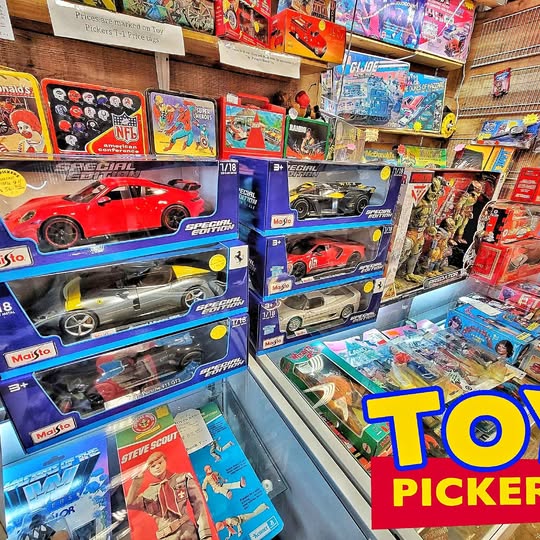 Boxed die-cast toy cars, including red and dark models