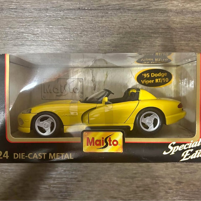 Yellow die-cast metal 1995 Dodge Viper RT/10 model car with open-top