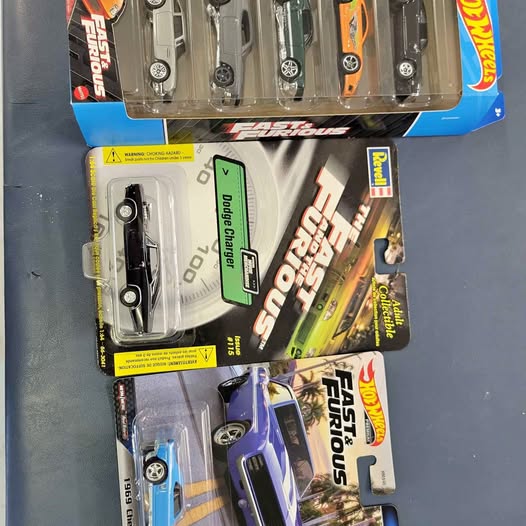 Diecast cars in blister pack with visible vehicles and branding