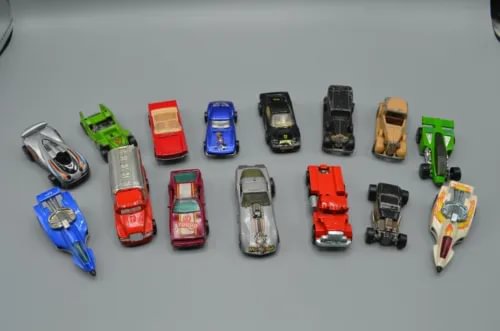 Vintage loose diecast car lot with multiple colored toy trucks and cars