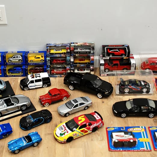 Diecast car collection with mixed model cars and boxed sets in various colors