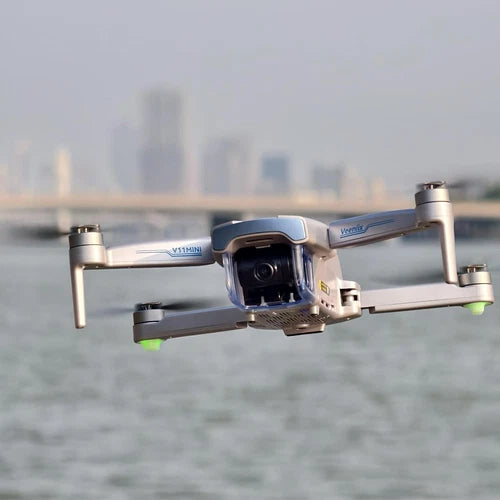White quadcopter drone with front camera and four propellers