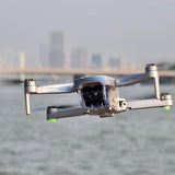 White quadcopter drone with front camera and four propellers