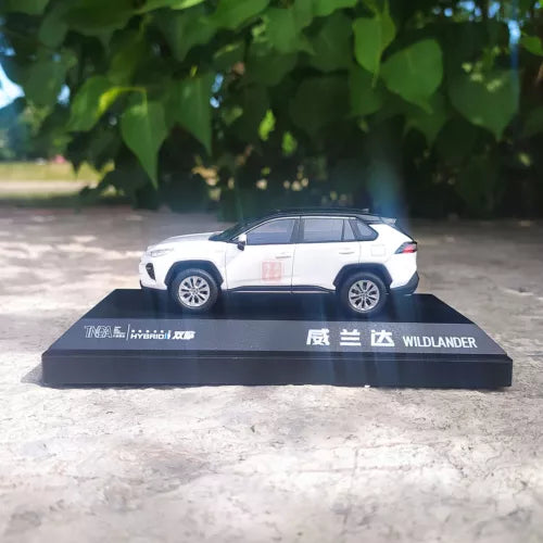 Diecast model car with white body and black roof, side view on base