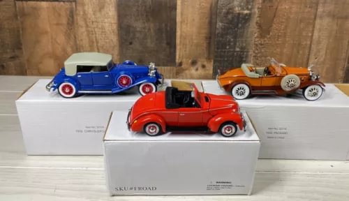 Diecast model car set with red, blue, and orange classic cars on display boxes