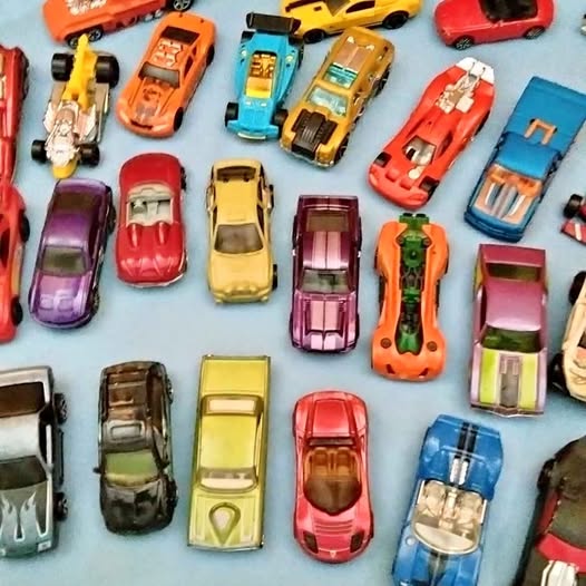Diecast toy car assortment with multiple colorful cars, various styles and details