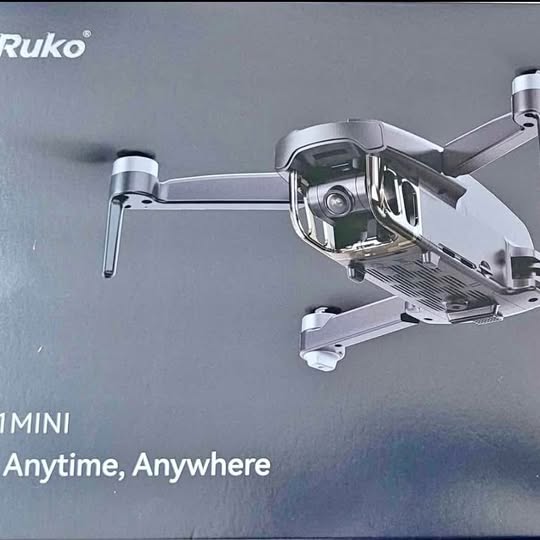 Silver mini drone with attached camera and two front landing legs