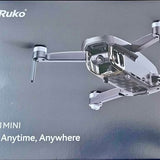 Silver mini drone with attached camera and two front landing legs