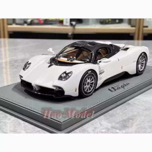White supercar diecast model with black accents, on gray display base
