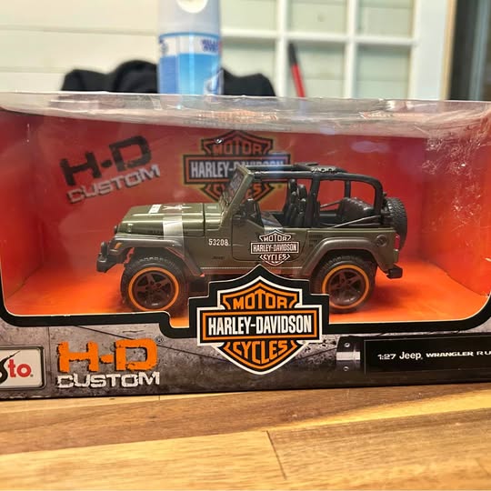 Green diecast off-road vehicle in clear Harley-Davidson blister packaging