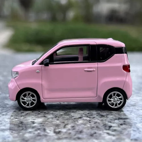 Pink 1/64 scale diecast mini EV car model toy, side view with silver wheels.