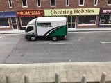 Diecast box lorry model with white cab and green stripe on the side
